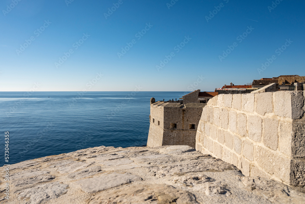 Amazing Dubrovnik city fortified walls used as the scene for popular TV show with dragons and knights towering over blue, Adriatic sea