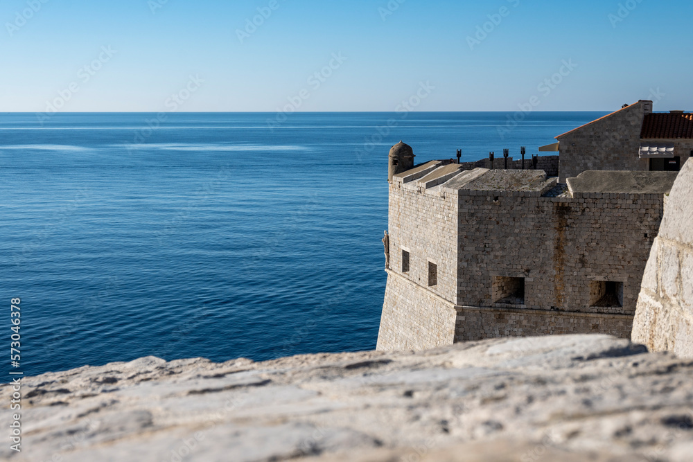 Amazing Dubrovnik city fortified walls used as the scene for popular TV show with dragons and knights towering over blue, Adriatic sea Amazing Dubrovnik city fortified walls used as the scene for popular TV show with dragons and knights towering over blue, Adriatic sea