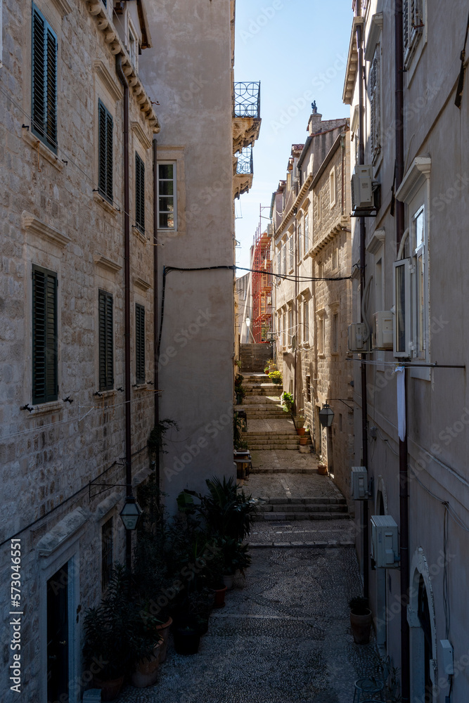 Beautiful Dubrovnik city streets with old houses and vintage balconies suspended above the stone paved streets
