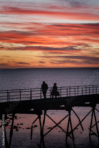 silhouette of a couple on a pier