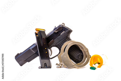 Gun, clip, bullets, handcuffs and drugs with copy space