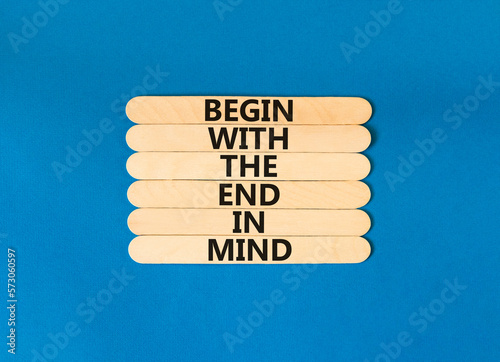 Begin in end of mind symbol. Concept words Begin with the end in mind on wooden stick. Beautiful blue table blue background. Business begin in end of mind concept. Copy space.