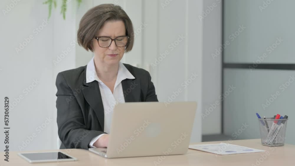 Old Businesswoman Coughing while Working on Laptop Old Businesswoman Coughing while Working on Laptop