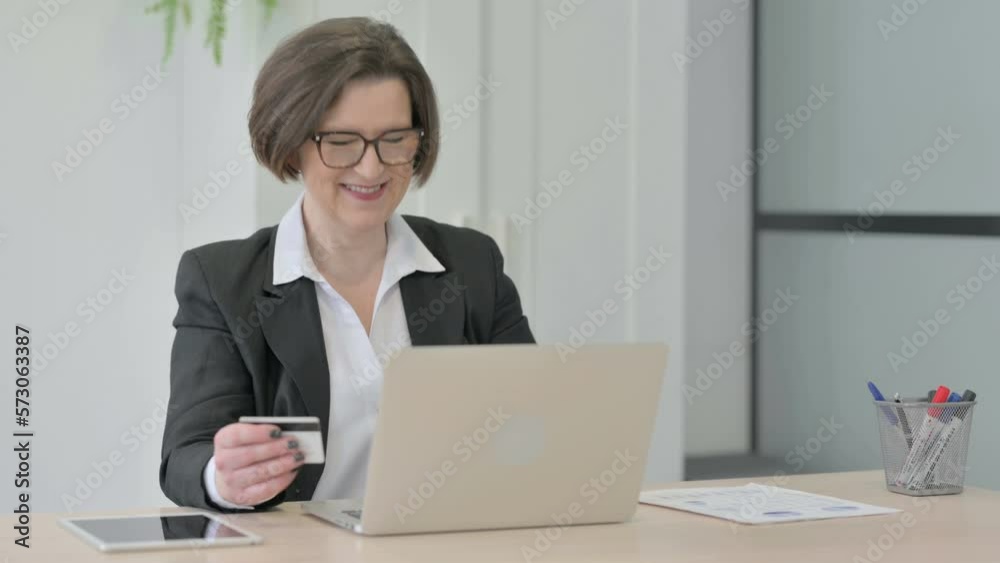Old Businesswoman making Successful Online Payment on Laptop Old Businesswoman making Successful Online Payment on Laptop