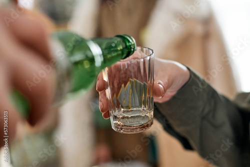 washing vodka of a military award in a glass with a shallow depth of field