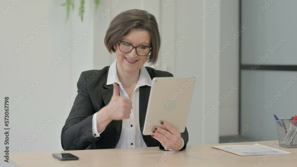 Old Businesswoman Celebrating Win on Digital Tablet Old Businesswoman Celebrating Win on Digital Tablet