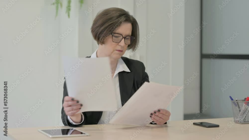 Old Businesswoman Reading Documents in Office, Paperwork Old Businesswoman Reading Documents in Office, Paperwork
