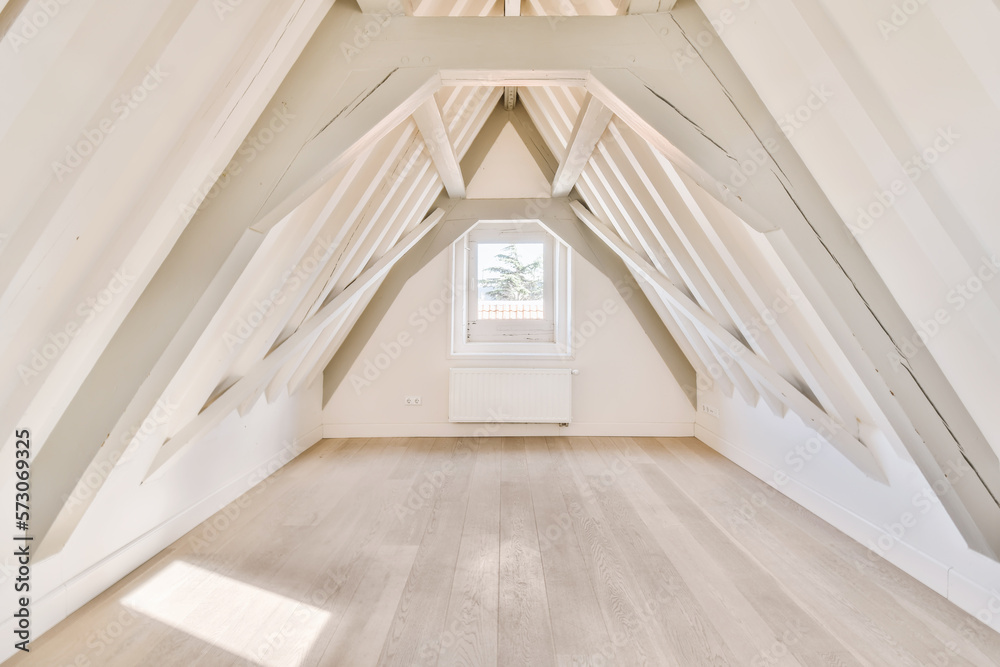 an attic room with white walls and wooden floors, all painted in the