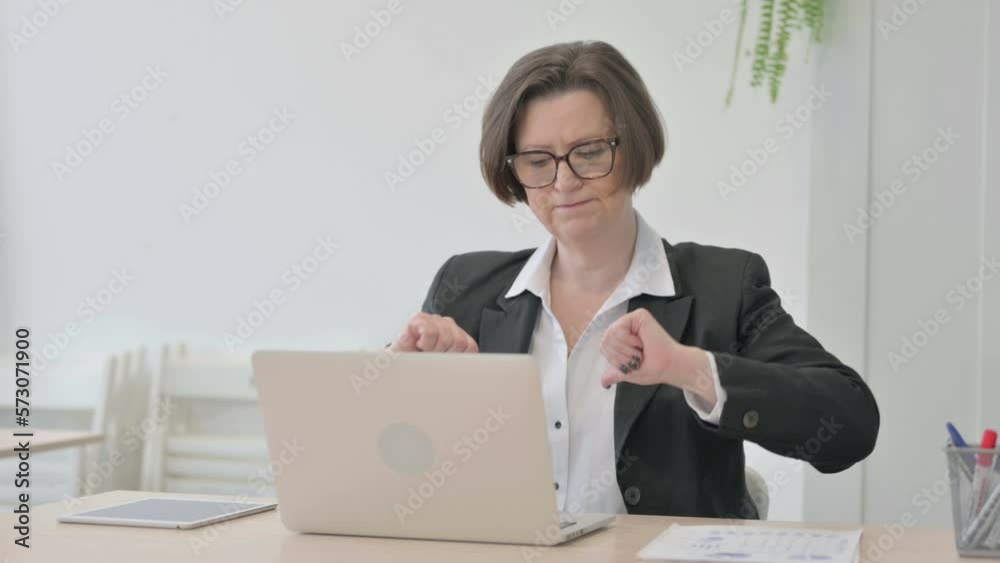 Old Businesswoman Reacting to Loss While Working in Office Old Businesswoman Reacting to Loss While Working in Office