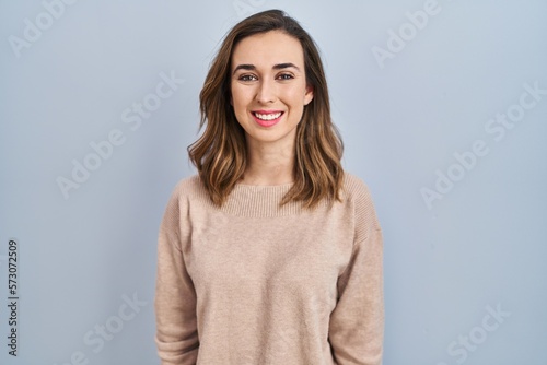 Young woman standing over isolated background with a happy and cool smile on face. lucky person.