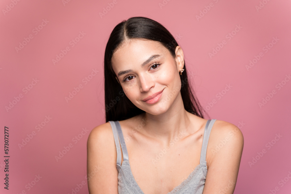 Young woman with makeup against pink background Young woman with makeup against pink background