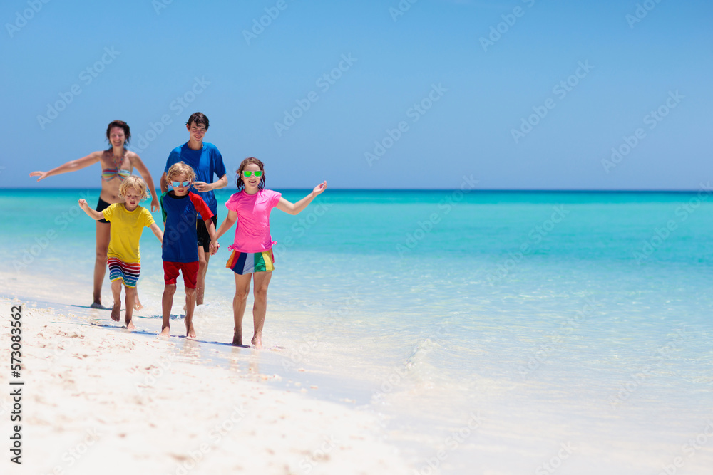 Family vacation. Parent and kids on tropical beach