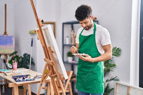 Young arab man artist smiling confident drawing at art studio