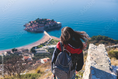 View of Sveti Stefan, a town in Budva Municipality, Budva Riviera, on the Adriatic sea coast, Saint Stephen island, Montenegro, sunny day with a blue sky, travel to Montenegro © tsuguliev