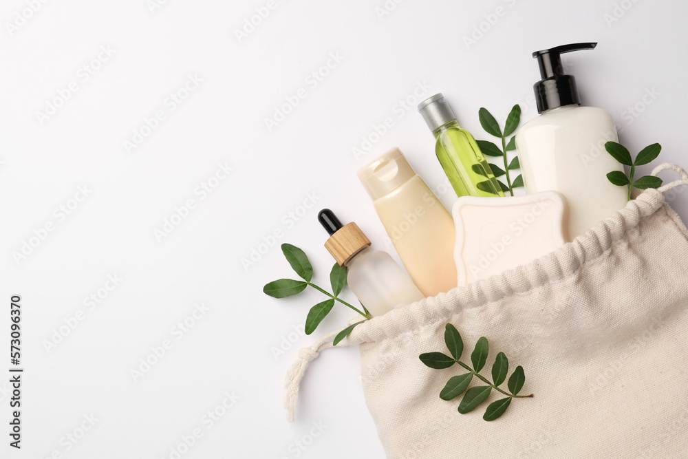 Preparation for spa. Compact toiletry bag, twigs and cosmetic products on white background, flat lay. Space for text Preparation for spa. Compact toiletry bag, twigs and cosmetic products on white background, flat lay. Space for text