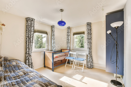 a child's room with a cribt bed, desk and chair in the corner of the room photo