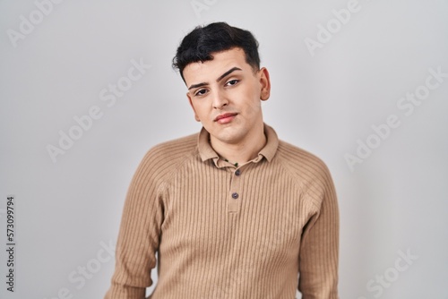 Non binary person standing over isolated background looking sleepy and tired, exhausted for fatigue and hangover, lazy eyes in the morning. © Krakenimages.com
