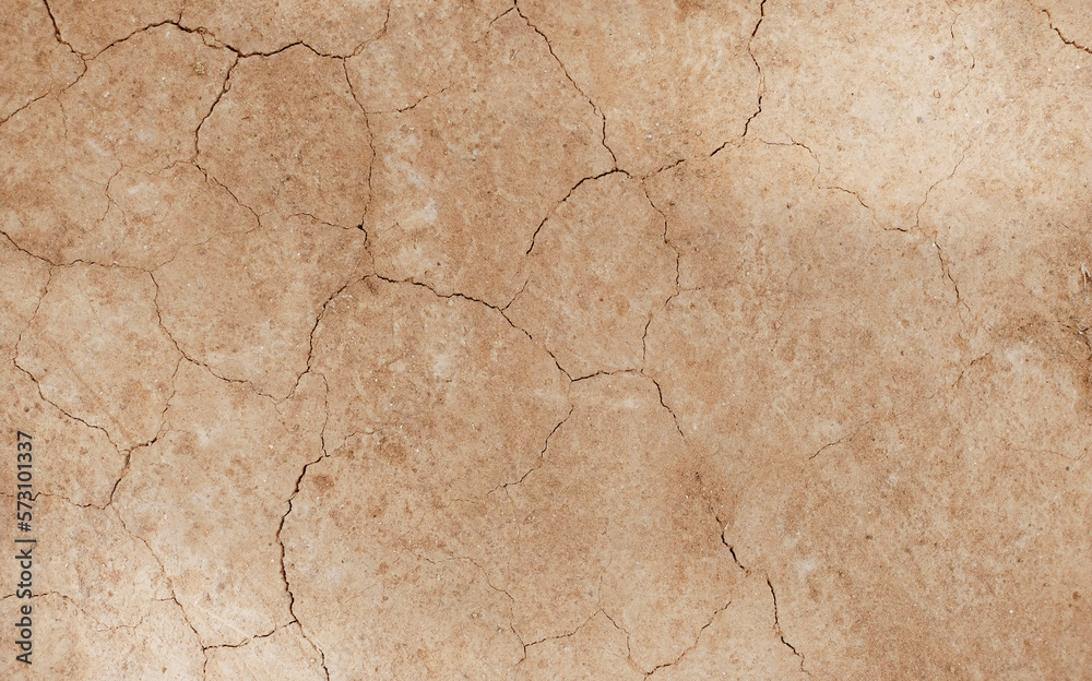 Fototapeta premium Cracked ground background in the top view for graphic design or wallpaper