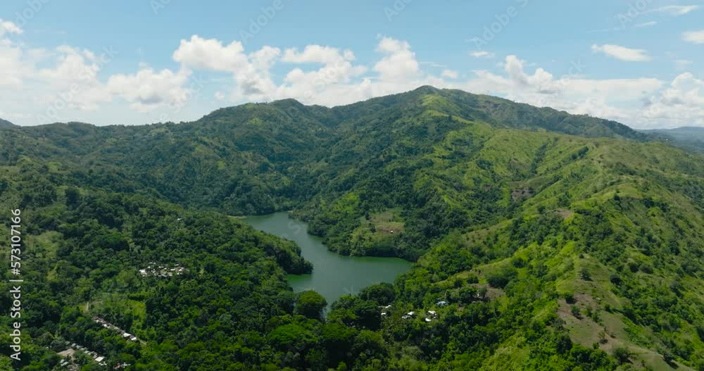 Aerial drone of lake among the mountains with tropical vegetation. Lake Balanan. Negros, Philippines Aerial drone of lake among the mountains with tropical vegetation. Lake Balanan. Negros, Philippines