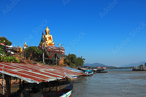 Statue Buddha on the banks of the Mekong River photo