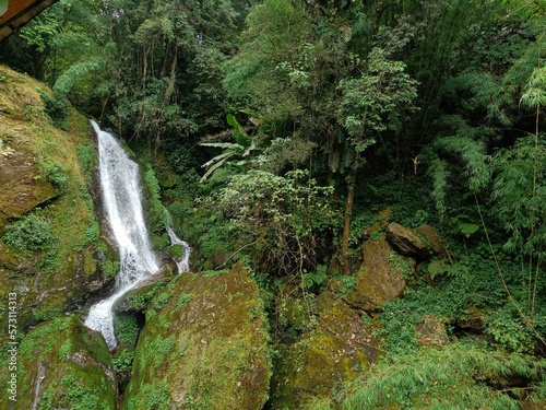 Panoramic landscape view of Butterfly Waterfalls or Seven Sister Waterfalls surrounded by lush green forest, a famous tourist place in Sikkim, India