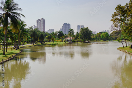 Landscape of park with lake, trees and building in Bangkok, Thailand