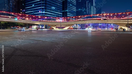 Car traffic at night timelapse in a city crossroad with a modern bridge, Chengdu, Sichuan province, China