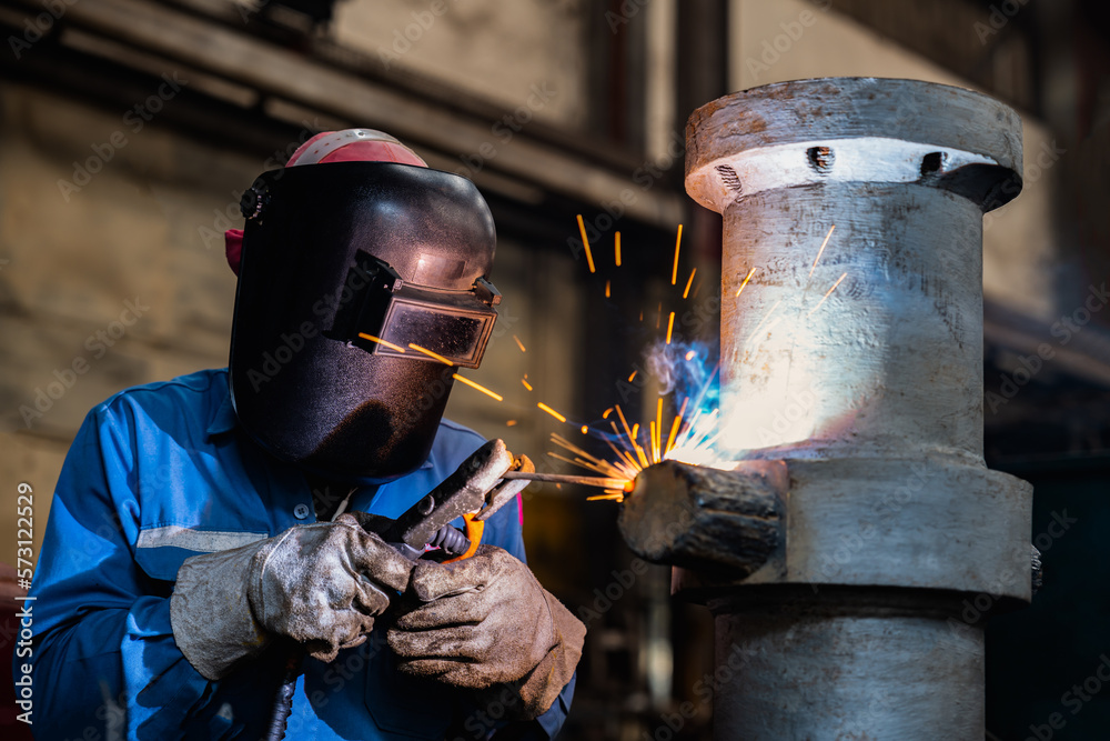 Industrial welder welding fabricated construction in factory, Welding