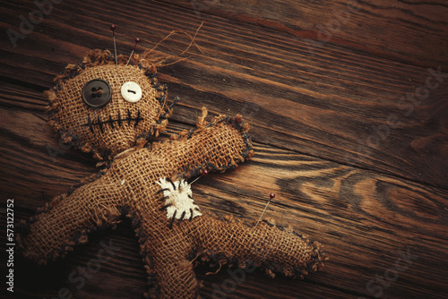 Voodoo doll on a wooden background. Closeup. An ancient spell. Witchcraft.