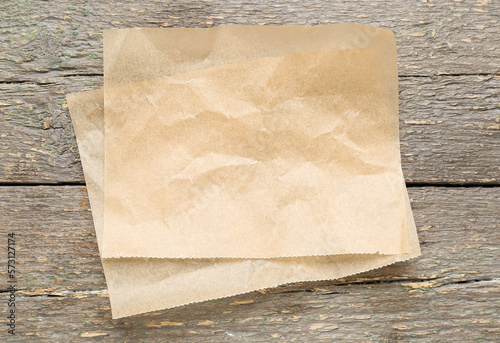 Sheets of baking paper on wooden background