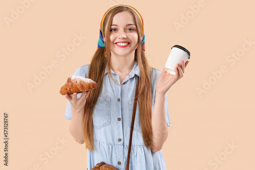 Smiling young woman holding...