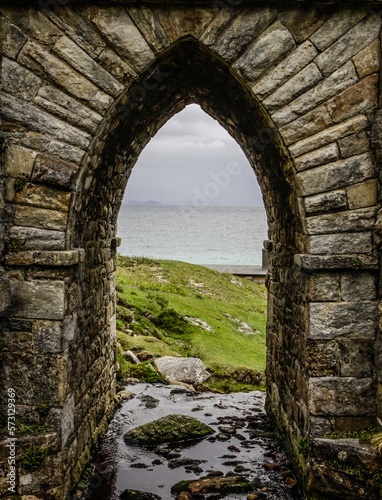 An arch below a stone bridge at Keem beach, Achill Island, Ireland © Anthony