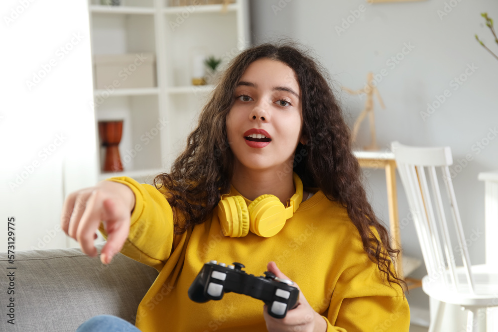 Teenage girl playing video game at home, closeup