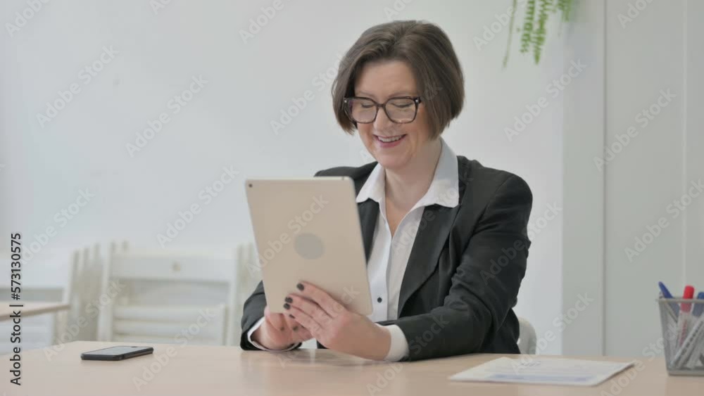 Old Businesswoman Celebrating Win on Digital Tablet Old Businesswoman Celebrating Win on Digital Tablet