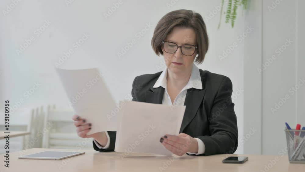 Old Businesswoman Reading Documents in Office, Paperwork Old Businesswoman Reading Documents in Office, Paperwork