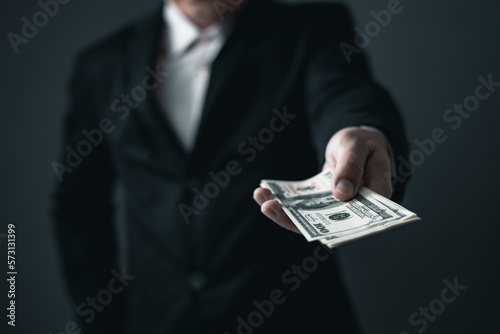 business man holding 100 cash bills Dollar currency, investment finance concept, success in business.