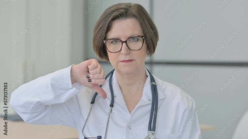 Portrait of Senior Female Doctor Doing Thumbs Down Portrait of Senior Female Doctor Doing Thumbs Down