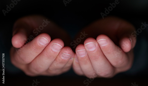 Hands together, open palm and dark for donation, giving or nonprofit mockup space for religion charity work. Hand sign, mock up and pray for worship, gratitude or mindfulness in night at ngo workpace photo