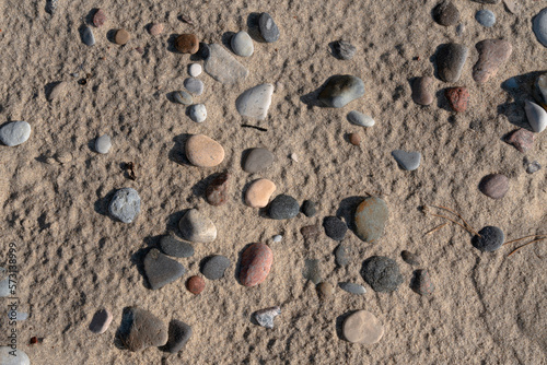 Colorful sea pebbles on the sand of the beach on the Baltic Sea, Curonian Spit, Kaliningrad region, Russia