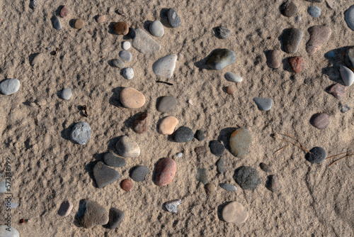 Fototapeta Naklejka Na Ścianę i Meble -  Colorful sea pebbles on the sand of the beach on the Baltic Sea, Curonian Spit, Kaliningrad region, Russia