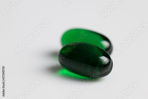 green pills on a white background