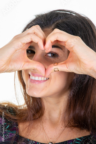Beautiful romantic woman showing heart hand gesture I love you sign smiling happy on white background