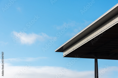 A corner of a modern roof construction with blue sky