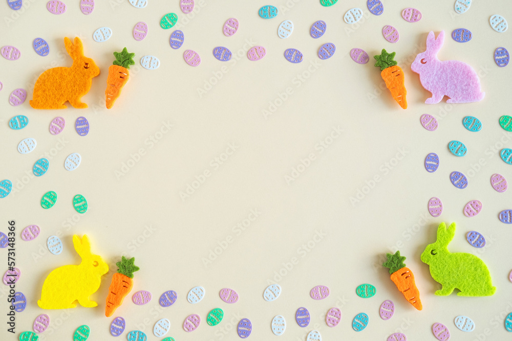 Colorful eggs confetti and rabbits on pastel background