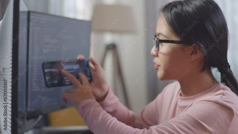 Close Up Of Asian Teen Girl Programmer Looking At Smartphone Then Celebrating The Success While Creating Software Engineer Developing App, Program, Video Game On Desktop Computer At Home
Close Up Of Asian Teen Girl Programmer Looking At Smartphone Then Celebrating The Success While Creating Software Engineer Developing App, Program, Video Game On Desktop Computer At Home