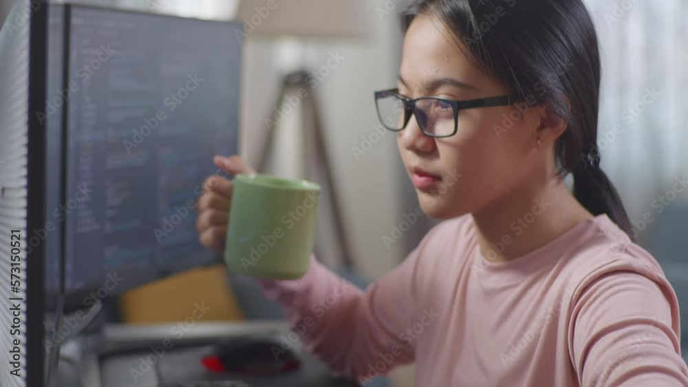 Close Up Of Asian Teen Girl Programmer Drinking Water While Creating Software Engineer Developing App, Program, Video Game At Home On Desktop Computer At Home. Terminal With Coding Language
Close Up Of Asian Teen Girl Programmer Drinking Water While Creating Software Engineer Developing App, Program, Video Game At Home On Desktop Computer At Home. Terminal With Coding Language