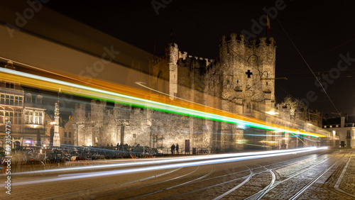 Fototapeta Naklejka Na Ścianę i Meble -  Tramway lightrays near medieval castle in Gent, Belgium in January 2023
