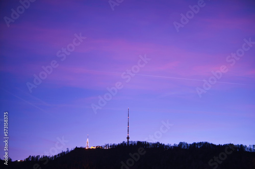 Uetliberg with television tower and observation tower at sunset in the blue hour in the city of Zurich in Switzerland