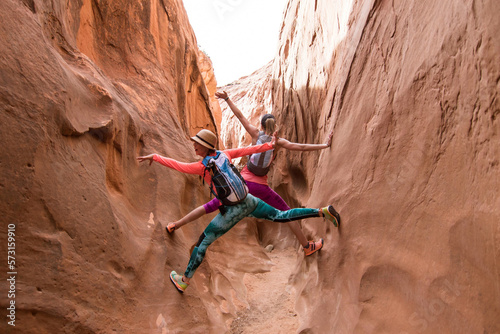 Two women exploring slot canyon, Grand Staircase-Escalante National Monument, Utah, USA photo