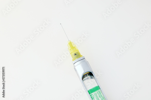 Steel dental syringe for local anesthesia, isolated on white. Carpool syringe for anesthesia in dentistry. Thin needle on a syringe for anesthesia in dentistry